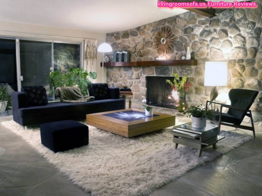 Excellent Living Room Furniture Design Ideas With Fireplace And Black Sofa On Cream Fur Rug Also Stone Walls As Well As Delightful Lighting