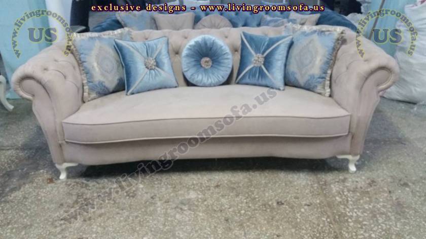 brown fabric chesterfield with blue pillows