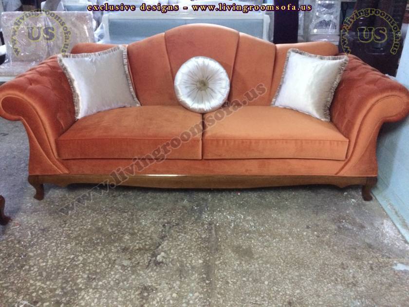 coral velvet chesterfield sofa and silver pillows