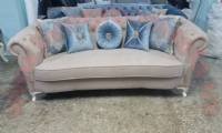 brown fabric chesterfield with blue pillows